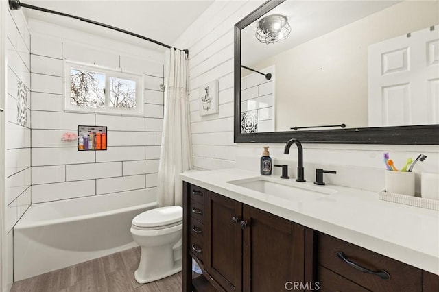 bathroom with vanity, shower / tub combo, wood finished floors, and toilet