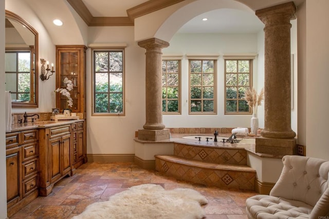 5423 Calzada Del Bosque, Rancho Santa Fe, CA 92067 - bathroom featuring ornate columns, stone tile floors, plenty of natural light, vanity, and crown molding