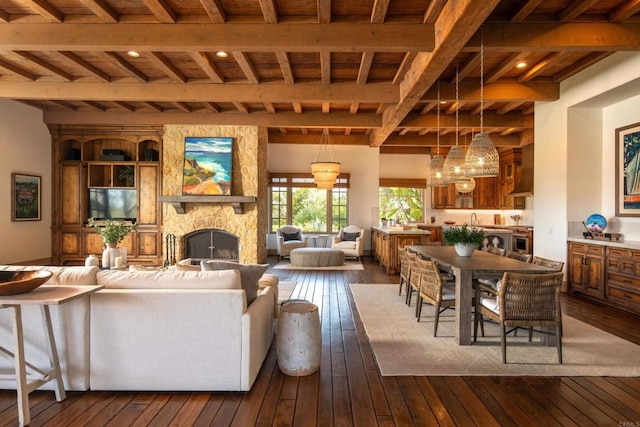 5423 Calzada Del Bosque, Rancho Santa Fe, CA 92067 - living room featuring dark wood-style flooring, a fireplace, a chandelier, and a wood ceiling with exposed beams