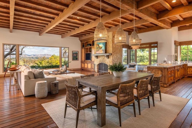 5423 Calzada Del Bosque, Rancho Santa Fe, CA 92067 - dining space with hardwood / wood-style flooring, a wooden ceiling with exposed beams, and a stone fireplace