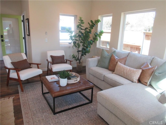 living room with dark wood-type flooring and baseboards