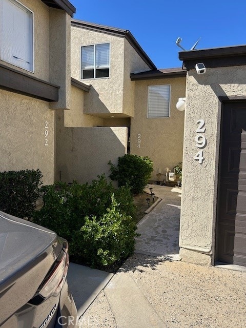 view of property exterior featuring a garage and stucco siding