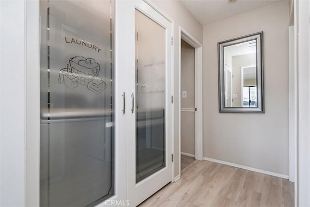 bathroom with wood finished floors and baseboards