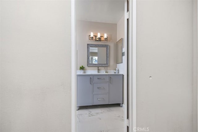 bathroom featuring marble finish floor and vanity