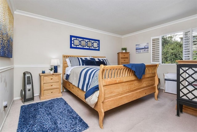 carpeted bedroom featuring crown molding and baseboards