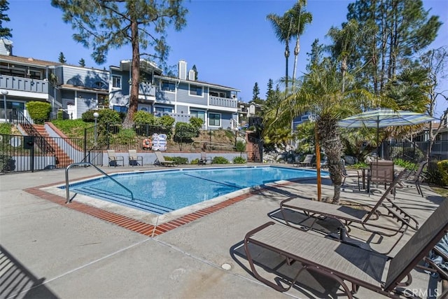 pool featuring a patio and fence