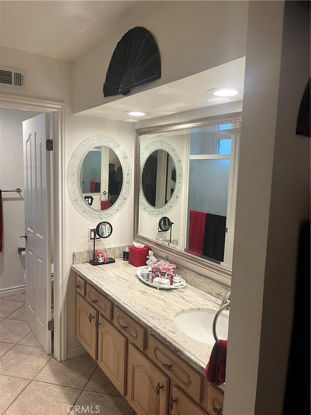 bathroom featuring visible vents, vanity, and tile patterned floors