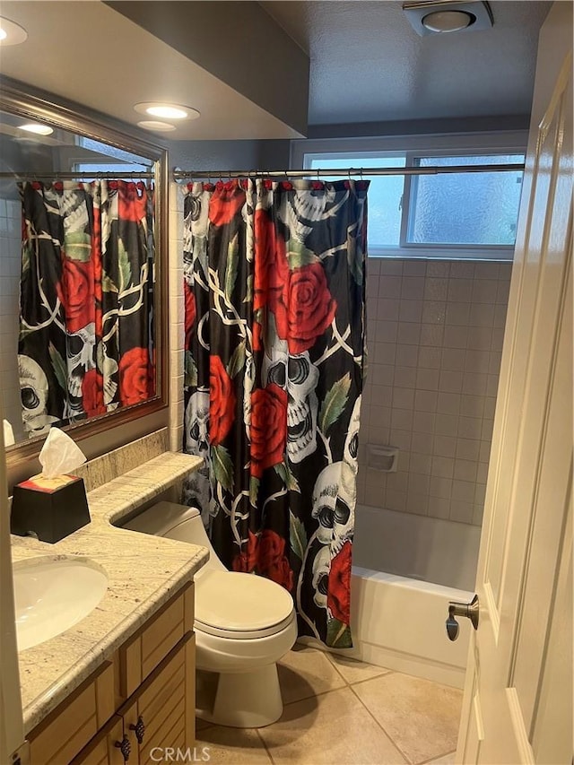 bathroom with toilet, shower / tub combo, vanity, and tile patterned floors