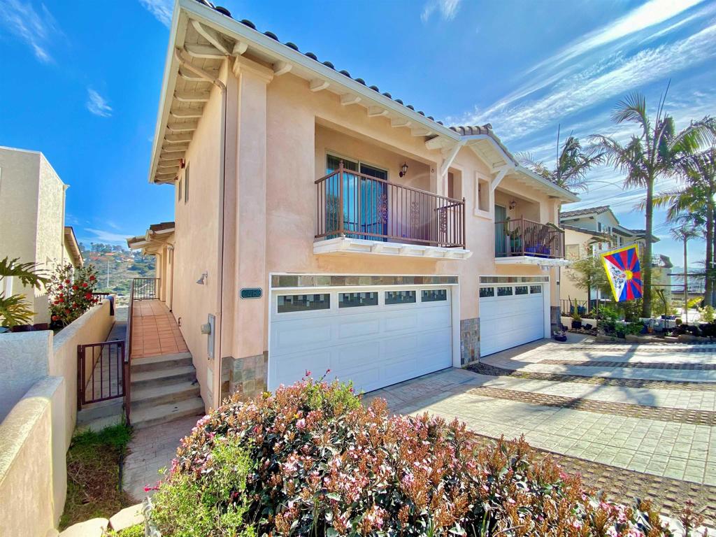 view of front of home featuring a garage, concrete driveway, stone siding, and stucco siding