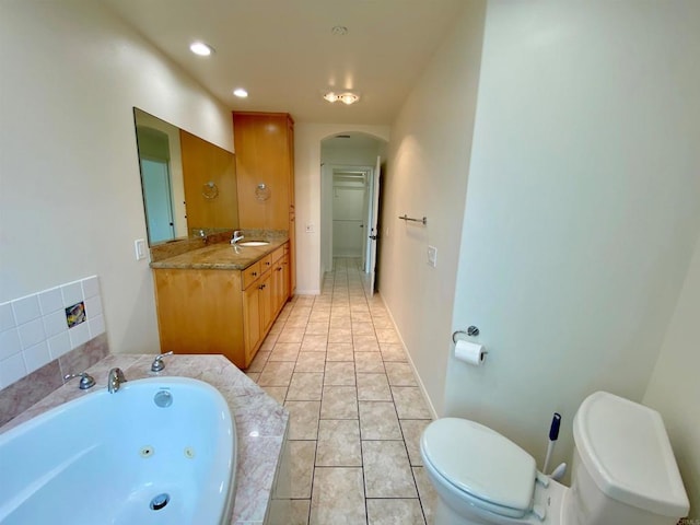 full bathroom with tile patterned floors, toilet, recessed lighting, a whirlpool tub, and vanity
