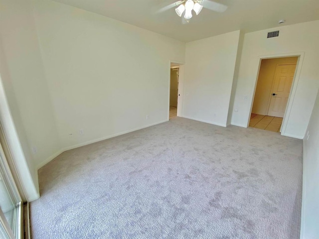 unfurnished bedroom with light carpet, baseboards, visible vents, and a ceiling fan