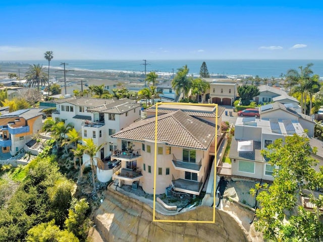 drone / aerial view featuring a residential view and a water view