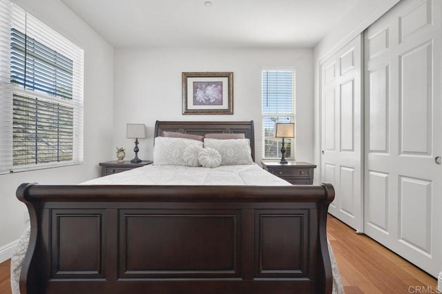 bedroom featuring light wood-style floors and a closet