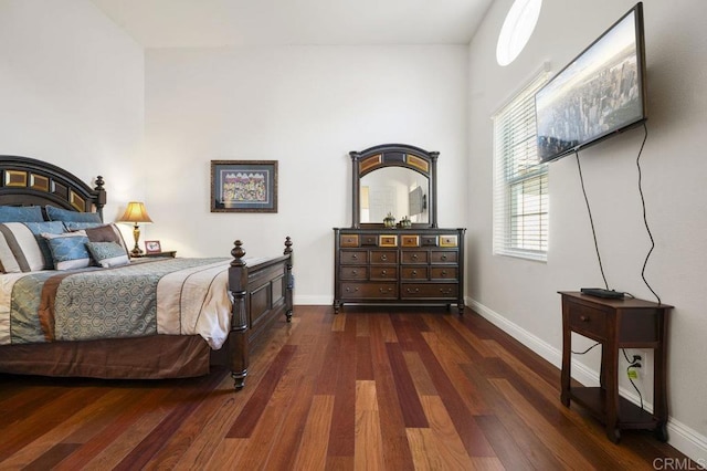 bedroom featuring dark wood-style flooring and baseboards