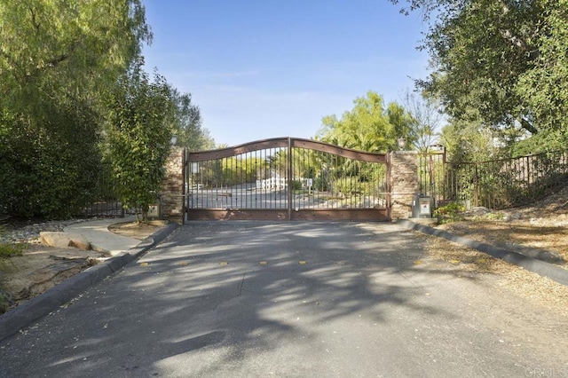 view of gate with fence