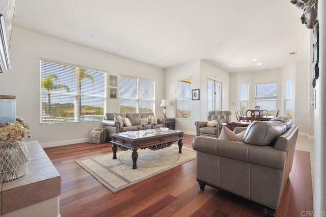 living room featuring dark wood finished floors and baseboards