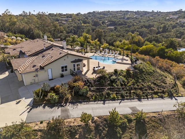 birds eye view of property with a forest view