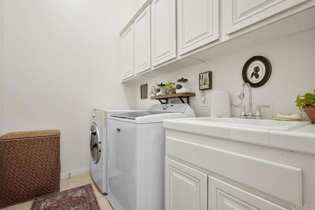 laundry room featuring light tile patterned floors, baseboards, a sink, and washer and dryer