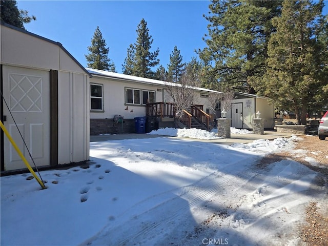 view of front facade with a storage shed and an outdoor structure