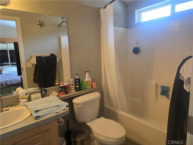 bathroom with shower / bath combo, a textured wall, toilet, ensuite bath, and vanity