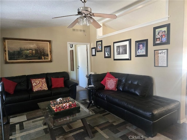 living room featuring visible vents, vaulted ceiling, and ceiling fan