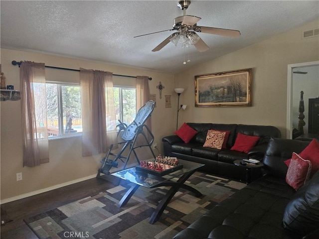 living area with dark wood-style floors, visible vents, vaulted ceiling, a textured ceiling, and baseboards