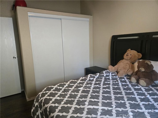 bedroom featuring a closet and dark wood finished floors