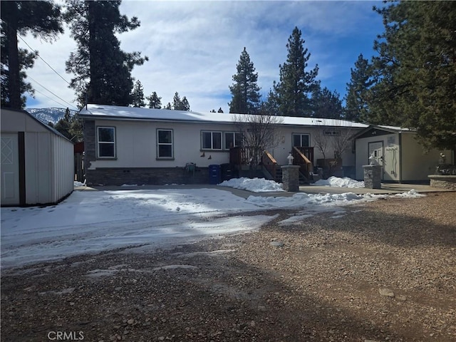 view of front of home featuring an outbuilding and a storage shed