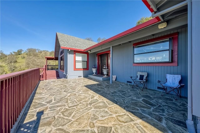 view of home's exterior featuring roof with shingles, crawl space, and a balcony