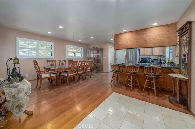 dining room with recessed lighting and light wood-style flooring