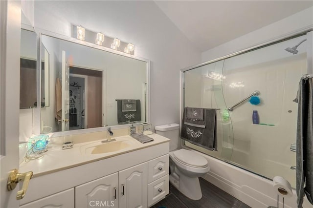 full bathroom featuring lofted ceiling, combined bath / shower with glass door, vanity, and toilet