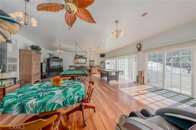 playroom with ceiling fan with notable chandelier, lofted ceiling, billiards, and wood finished floors