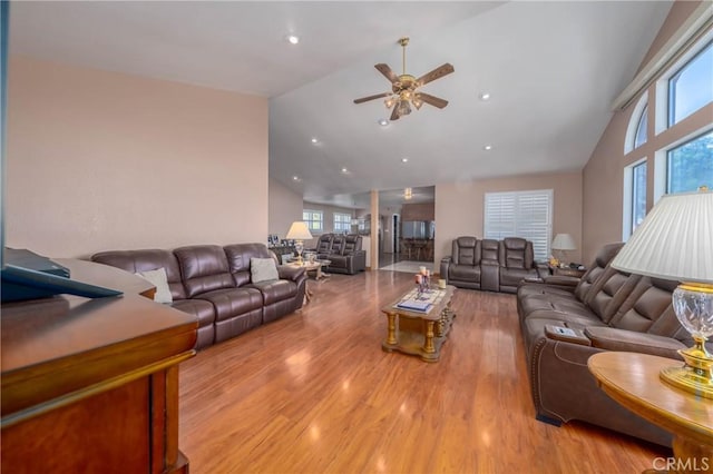 living room with high vaulted ceiling, recessed lighting, light wood-style flooring, and a ceiling fan