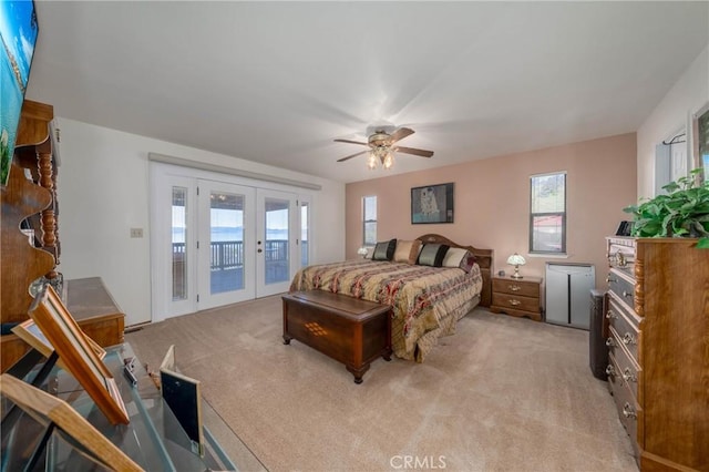 bedroom with light carpet, access to exterior, a ceiling fan, and french doors