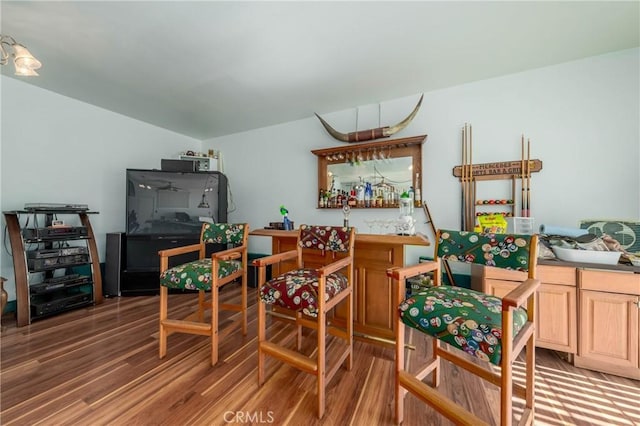 interior space featuring a dry bar and wood finished floors