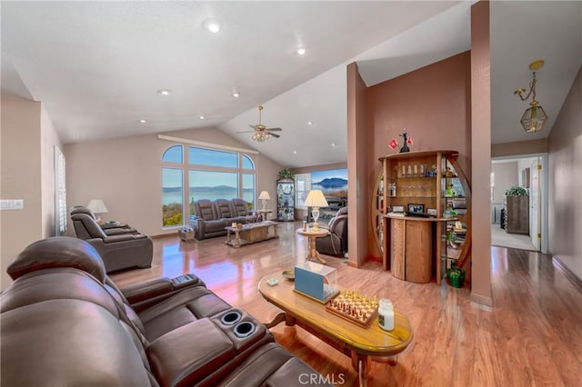 living area with ceiling fan, recessed lighting, baseboards, vaulted ceiling, and light wood-type flooring