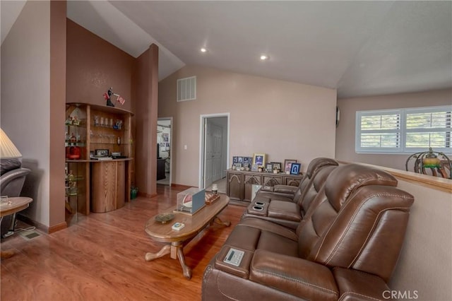 living room featuring lofted ceiling, recessed lighting, wood finished floors, visible vents, and baseboards