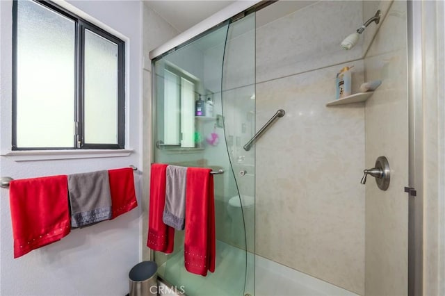 bathroom with a shower with shower door