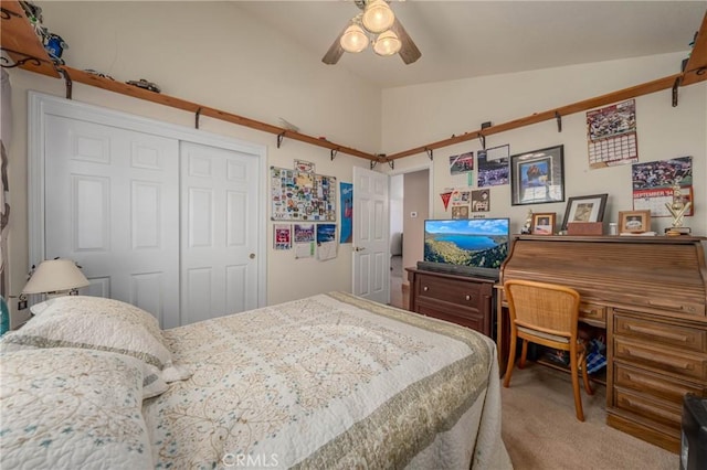 bedroom with carpet, a ceiling fan, vaulted ceiling, and a closet