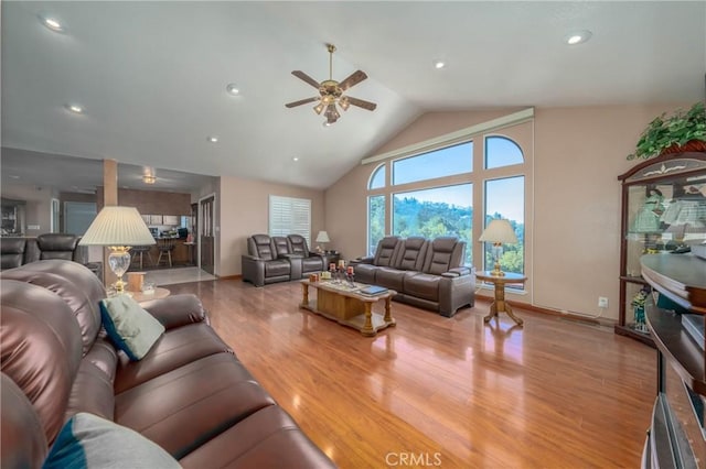 living room featuring vaulted ceiling, wood finished floors, a ceiling fan, and recessed lighting