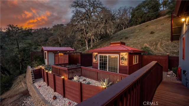 exterior space featuring an outdoor structure, a storage unit, and fence