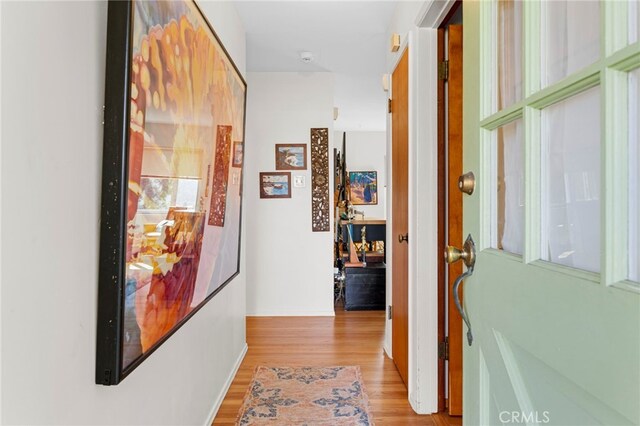 corridor with light wood-style flooring