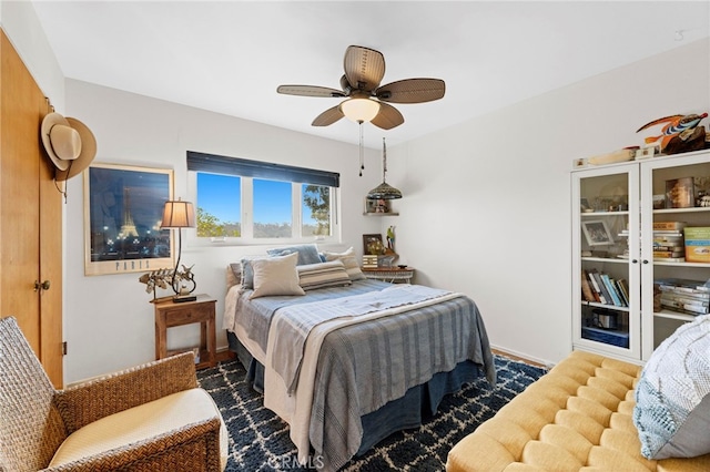 bedroom featuring a ceiling fan and baseboards