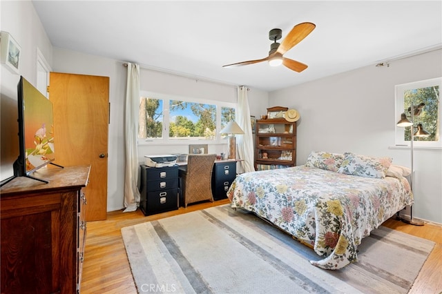 bedroom featuring a ceiling fan and light wood finished floors