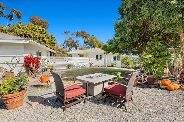 exterior space featuring fence and a fire pit