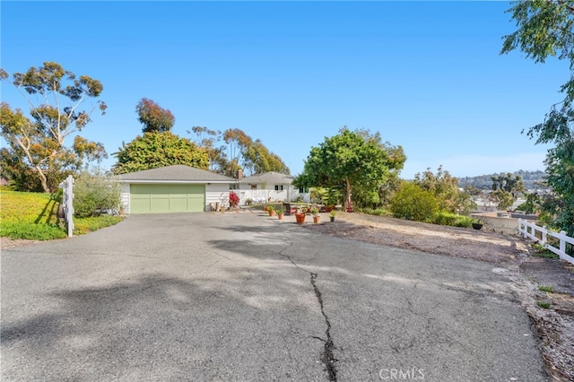 ranch-style home featuring fence