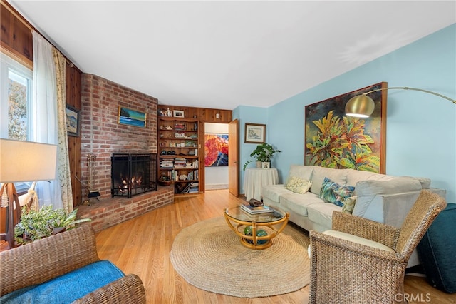 living room with a fireplace and wood finished floors