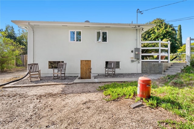 rear view of property with stucco siding