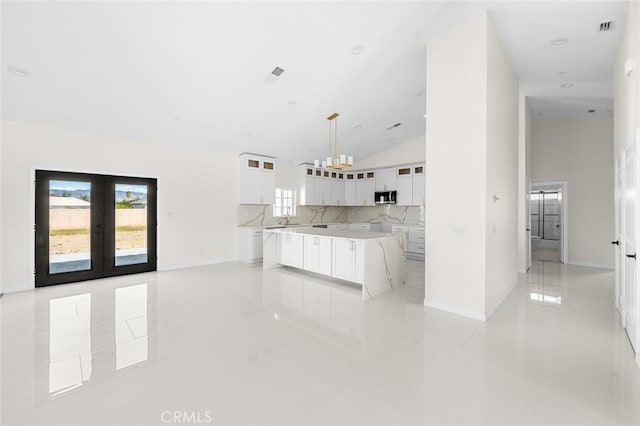 kitchen with white cabinets, modern cabinets, glass insert cabinets, light countertops, and pendant lighting