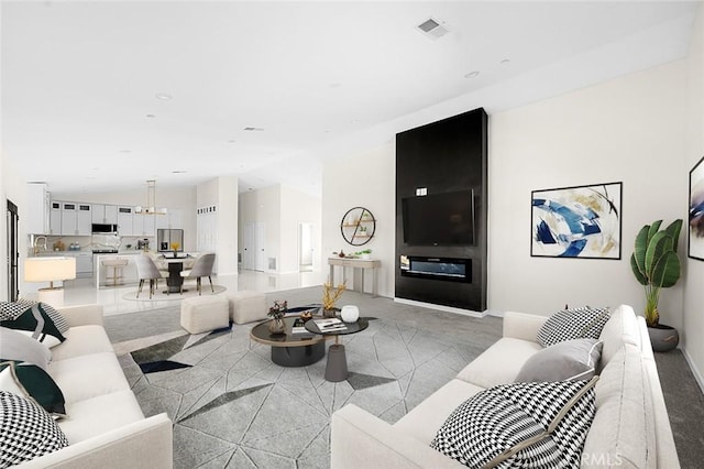 living area with light carpet, baseboards, visible vents, and vaulted ceiling